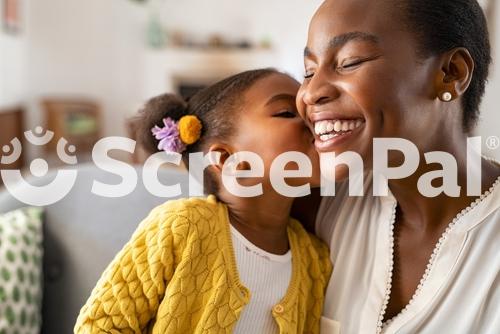 Close Up Of Beautiful Daughter Kissing Mother On Cheek At Home African Little Girl Giving Kiss To Happy Mother Lovely Black Female Child Kissing Cheerful And Proud Woman On Cheek For Mothers Day