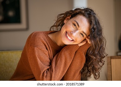 Happy Young Woman Sitting On Sofa At Home And Looking At Camera Portrait Of Comfortable Woman In Winter Clothes Relaxing On Armchair Portrait Of Beautiful Girl Smiling And Relaxing During Autumn