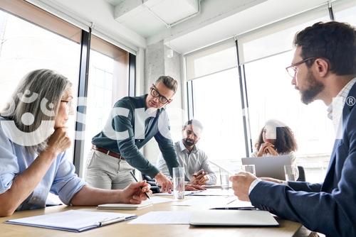 Male Mature Caucasian Ceo Businessman Leader With Diverse Coworkers Team Executive Managers Group At Meeting Multicultural Professional Businesspeople Working Together On Research Plan In Boardroom