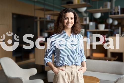 Young Smiling Latin Girl College Student Or Teacher Looking At Camera Standing In University Campus Happy Hispanic Millennial Woman Professional Posing In Modern Coworking Creative Office Space