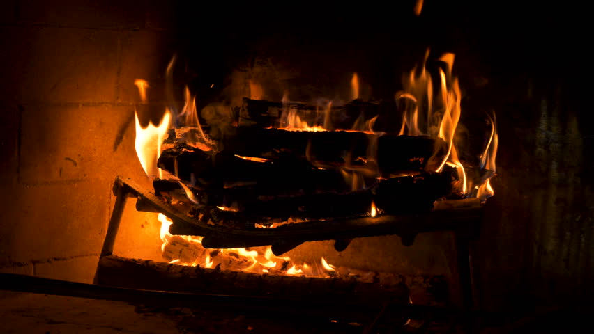 Brick Fireplace Closeup With Real Wood Log Burning Inside