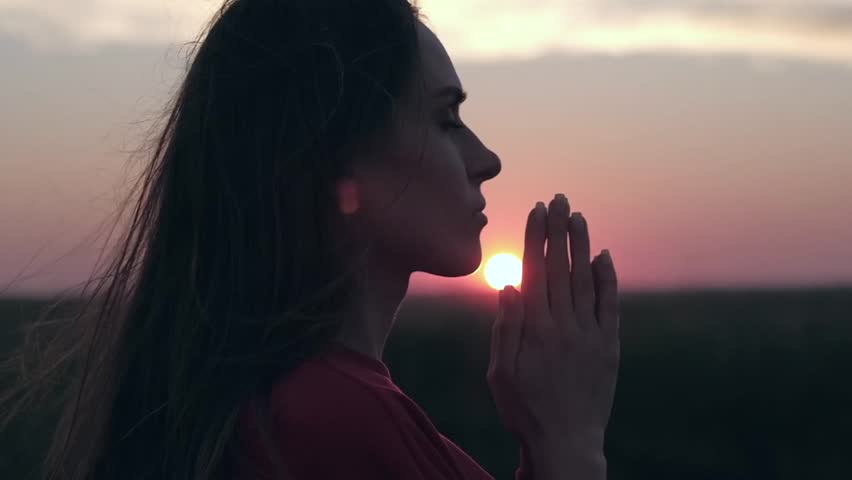 Silhouette Of Young Woman Praying With Closed Eyes In Nature At Sunset Religion Spiritual And Nature Concept