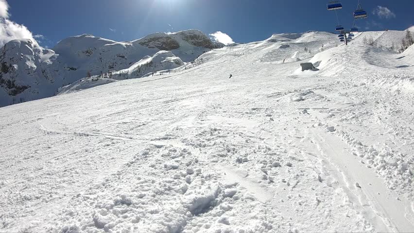 Young Boy Skiing A Man Enjoys Skiing In The Alpine Resort Skier Spraying Snow Into The Camera Stabilized Footage Slow Motion 