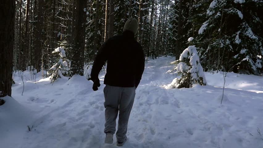 Man Walking In A Snowy Forest Slow Motion View Following A Young Male Hiking In A Frozen Forest On A Freezing Cold Winter Day In Sipoonkorpi National Park Uusimaa Finland