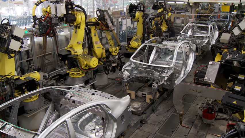 Robotic Line At The Automobile Plant Robot Manipulators Collect And Weld Car Bodies