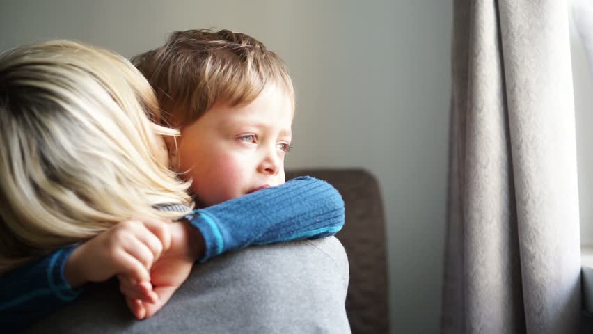 Upset Little Boy Hugging His Mother At Home