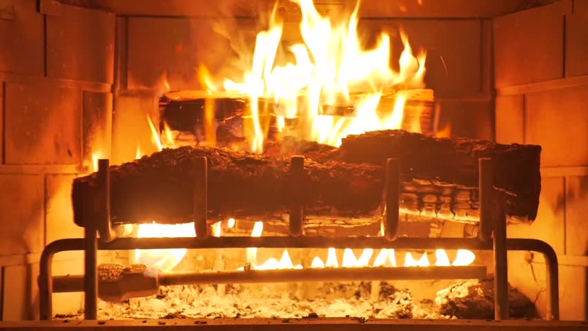 Medium Shot Of A Yule Log Burning In A Fireplace