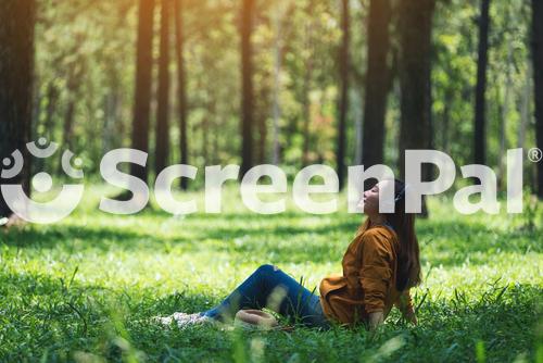 A Beautiful Young Asian Woman Enjoy Listening To Music With Headphone With Feeling Happy And Relaxed In The Park