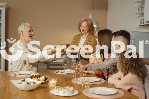 A Family Eating At The Table