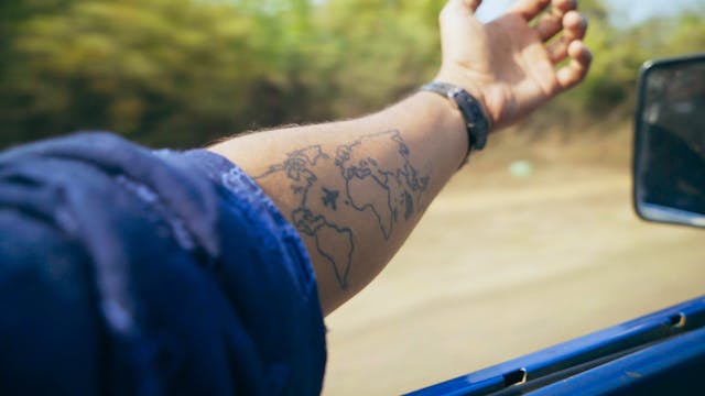 Man Driving With Hand Outside The Vehicle