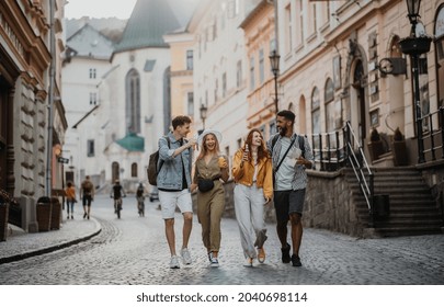 Front View Of Group Of Happy Young People With Drinks Outdoors On Street On Town Trip Laughing