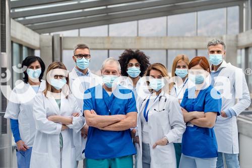 Group Of Doctors With Face Masks Looking At Camera Corona Virus Concept