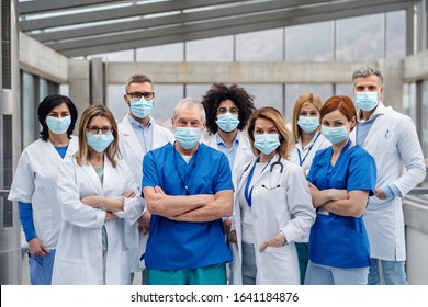 Group Of Doctors With Face Masks Looking At Camera Corona Virus Concept