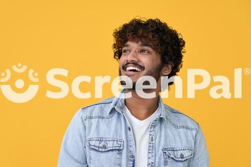 Happy Joyful Smiling Young Indian Man Looking Aside Up Thinking Of New Good Opportunities Dreaming Feeling Inspired And Proud Standing Isolated On Yellow Background Portrait