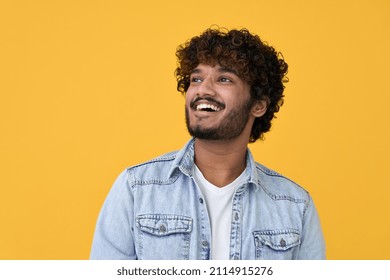 Happy Joyful Smiling Young Indian Man Looking Aside Up Thinking Of New Good Opportunities Dreaming Feeling Inspired And Proud Standing Isolated On Yellow Background Portrait