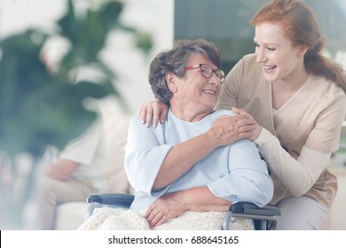 Happy Patient Is Holding Caregiver For A Hand While Spending Time Together