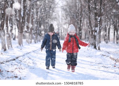 Kids Walk In The Park With First Snow