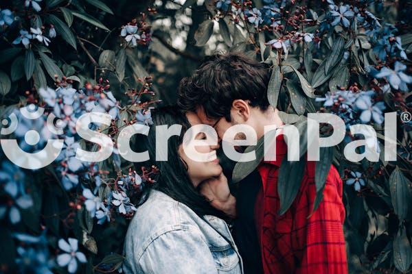 Man And Woman Standing Under Flowering Tree