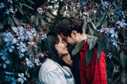 Man And Woman Standing Under Flowering Tree