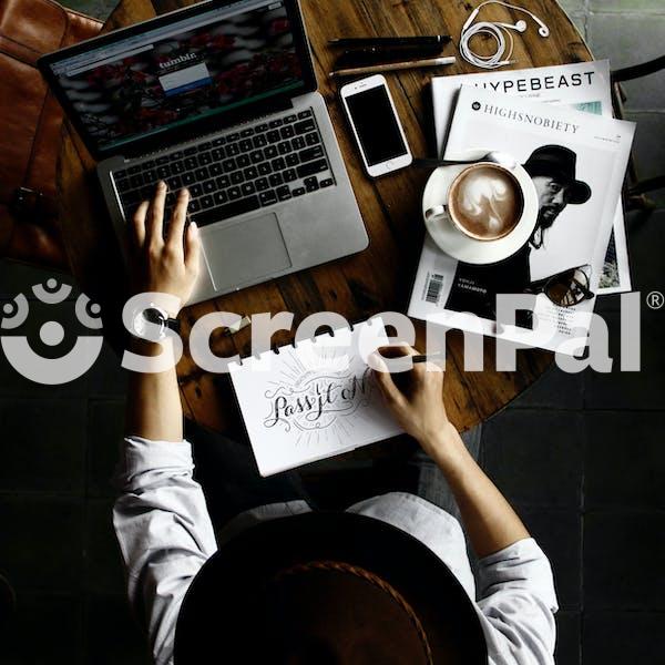 Person Sitting Facing Laptop Computer With Sketch Pad