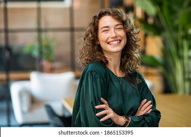 Portrait Of Young Smiling Woman Looking At Camera With Crossed Arms Happy Girl Standing In Creative Office Successful Businesswoman Standing In Office With Copy Space