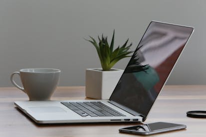 Silver Laptop And White Cup On Table