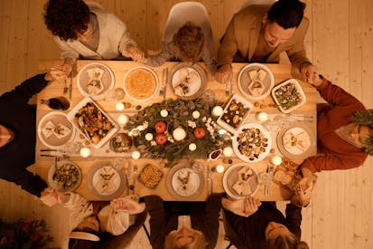 Top View Of A Family Praying Before Christmas Dinner