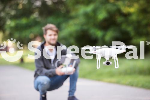 Young Hipster Man With Flying Drone Sunny Green Nature