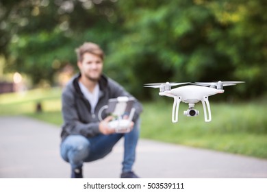 Young Hipster Man With Flying Drone Sunny Green Nature