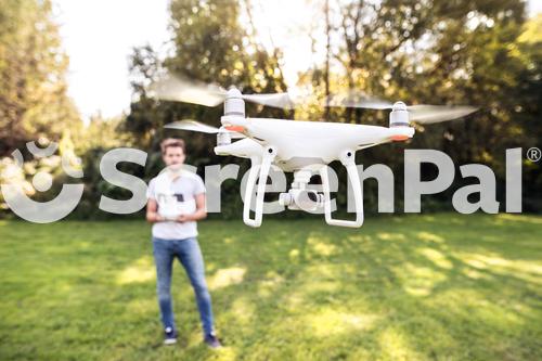 Young Hipster Man With Flying Drone Sunny Green Nature